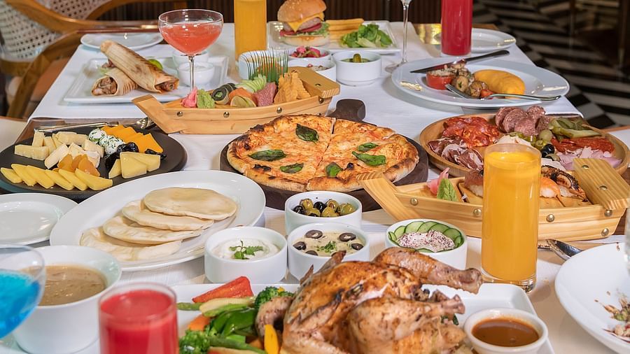 image of a table loaded with a variety of multi cuisine delicacies - The Claridges New Delhi