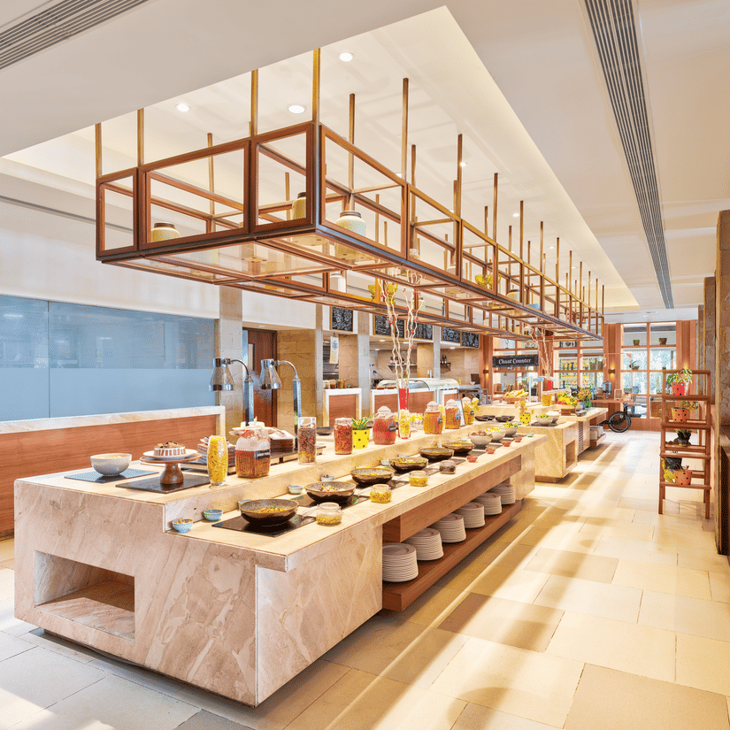 A buffet counter with multiple dishes, bowl, containers and plates | The Resort