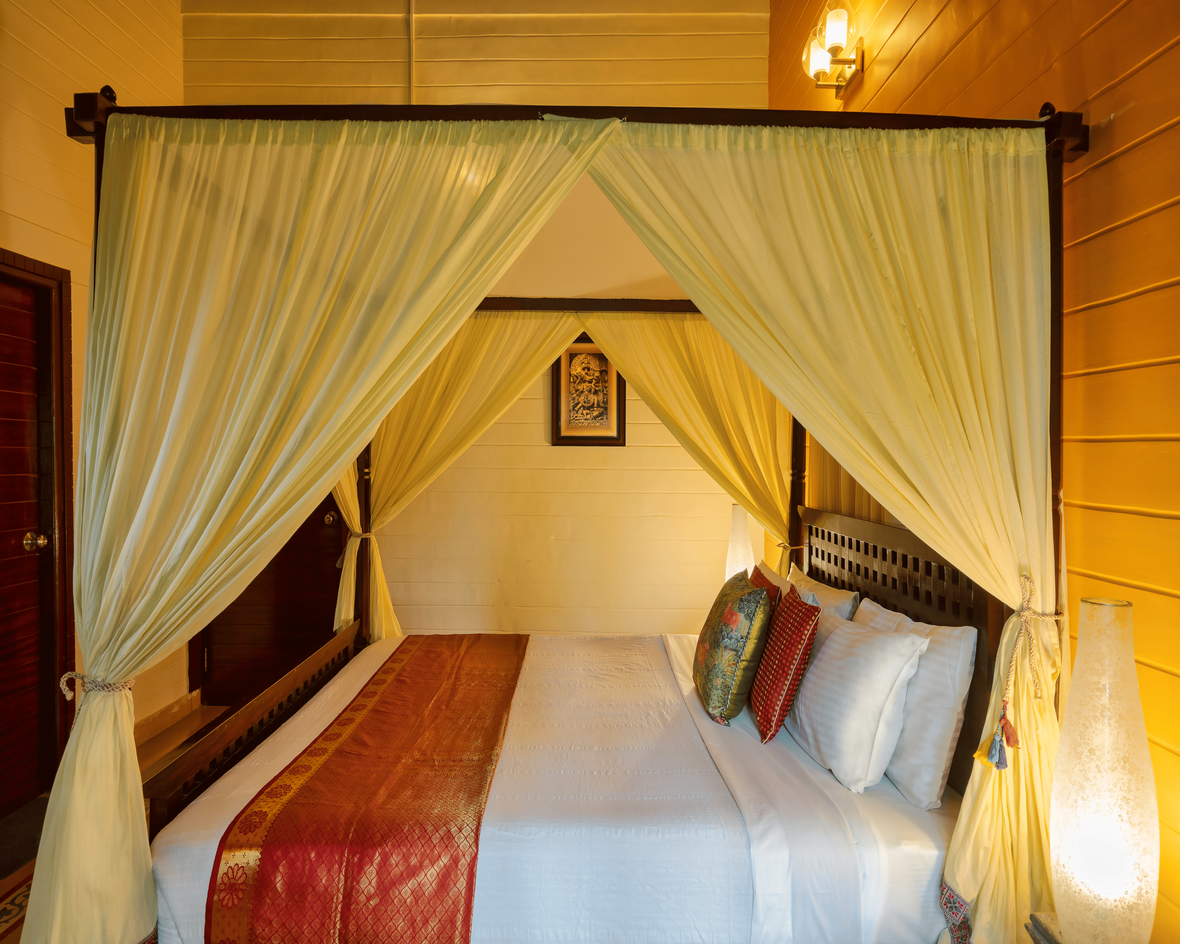 Bedroom with poster bed and seating