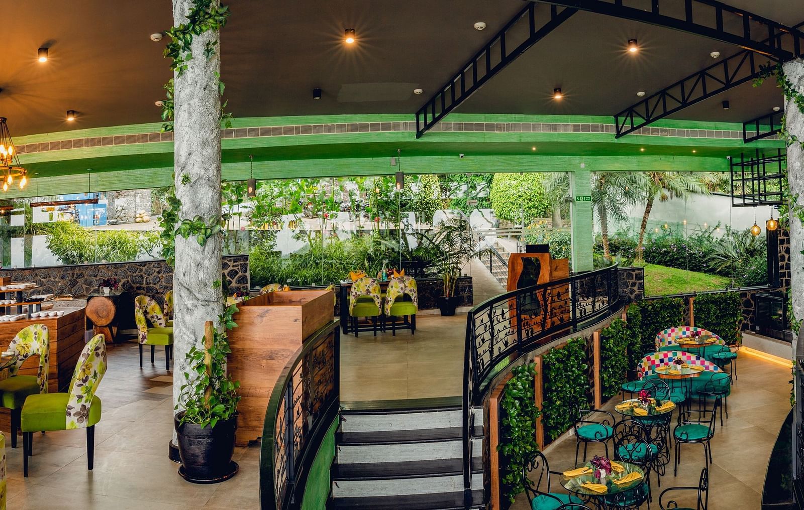 An image of a restaurant with seating arrangement and decoration - Great Trails Yercaud by GRT Hotels