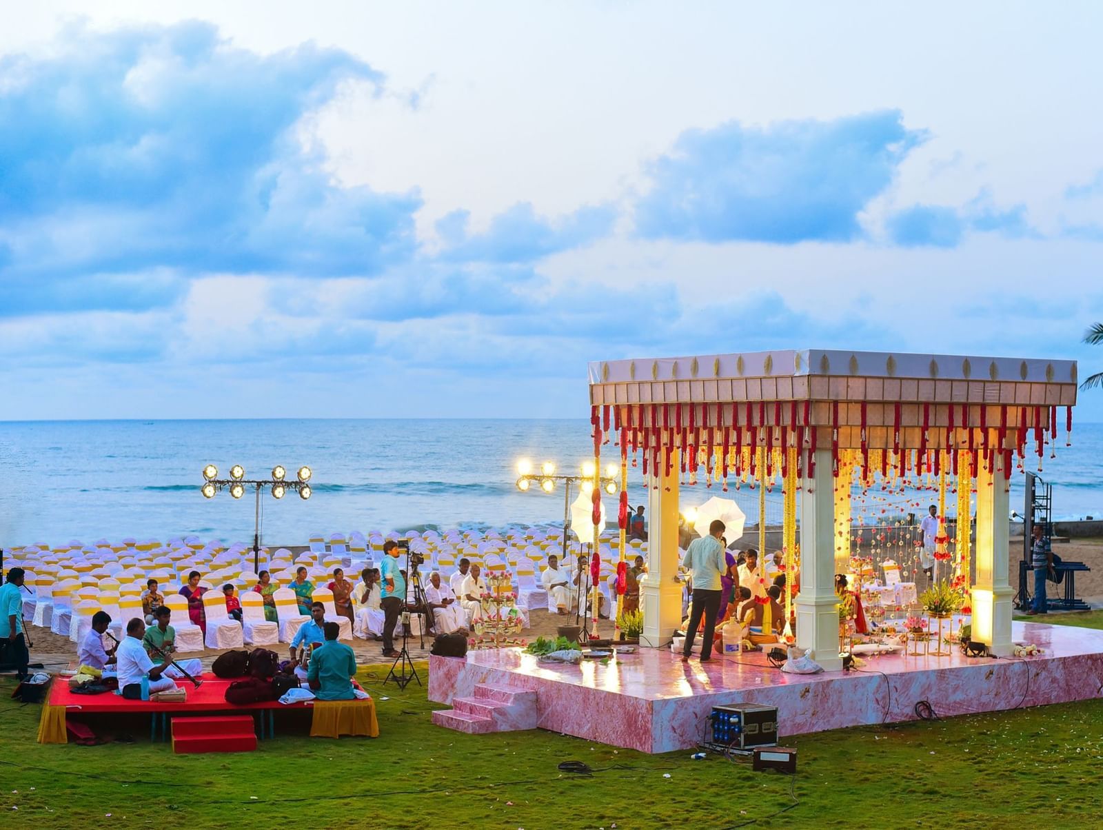 A grand outdoor wedding ceremony set up by the ocean, with a decorated canopy and seating | Horizon | Grand Bay Resort and Spa
