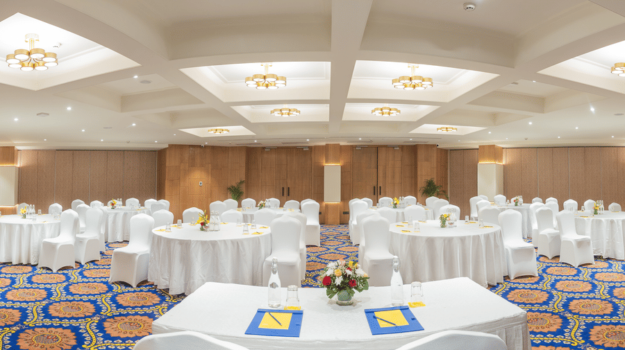 Rajputana Hall with cluster seating arrangement at Golden Tulip Jaipur City Center, featuring round tables and elegant banquet setup