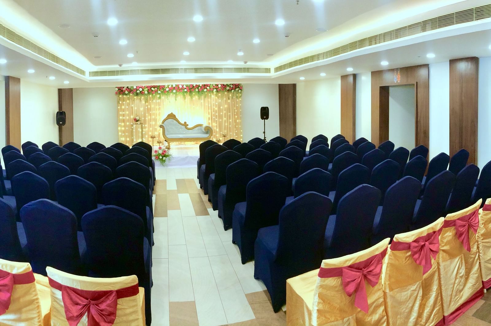 back view of the event hall with a stage at  Zibe Salem by GRT Hotels
