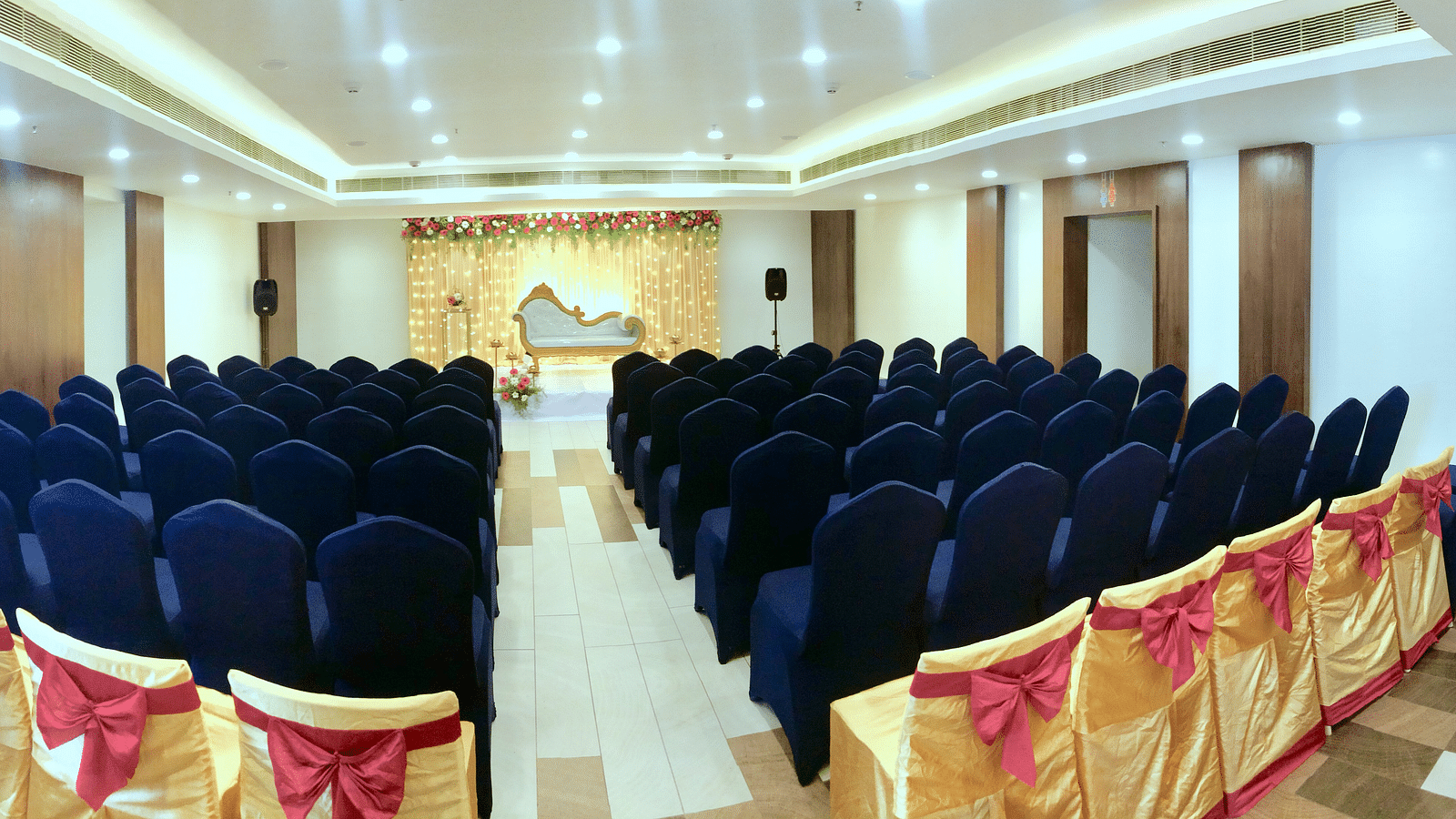 back view of the event hall with a stage at  Zibe Salem by GRT Hotels