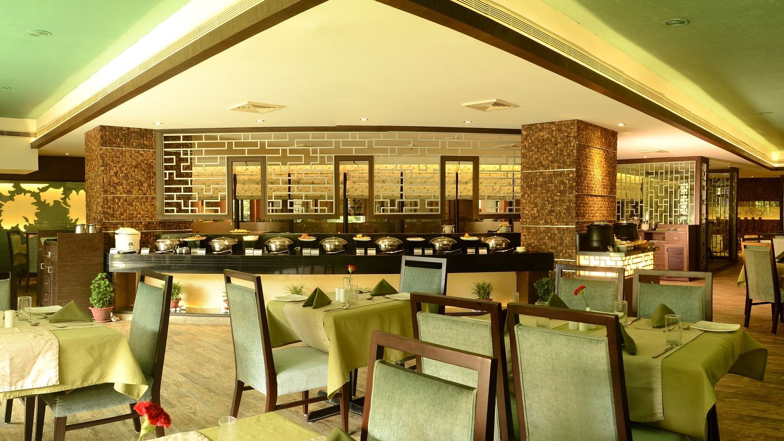 Dining area with tables set and ready, featuring culinary dishes prepared for serving guests.