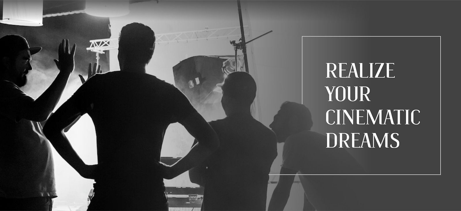 Black and white banner showing people in discussion on a film set, with the text 'Realise your cinematic dreams' displayed on the side.