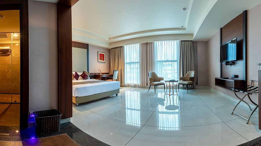 Panoramic view of a room featuring a bed and a sitting area at M Pro Palace.
