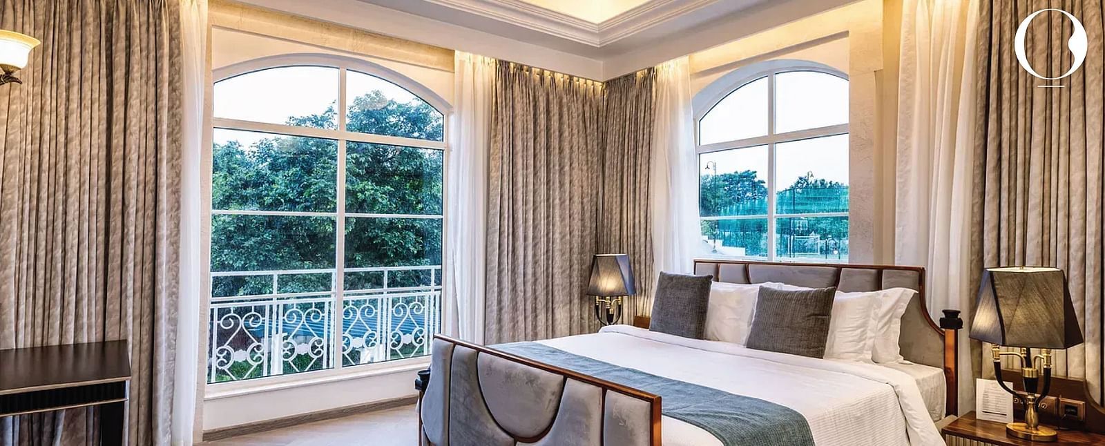 Full view shot of the bedroom of the Suite with ample natural light coming from the windows at Miros Hotels.