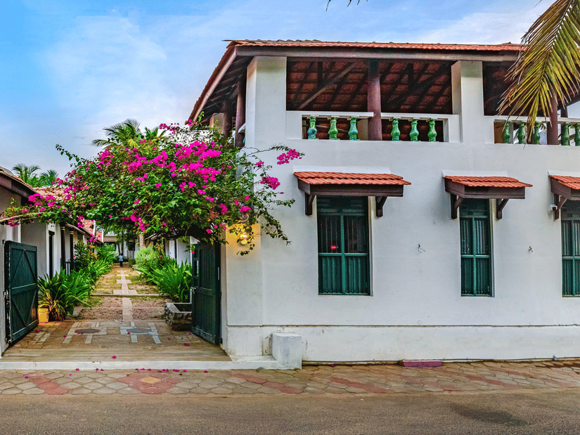 A view of the room cottage exterior with a cycle outside at Neemrana's Coconut Alley - 21st century, Tranquebar, one of the best Tharangambadi hotels.