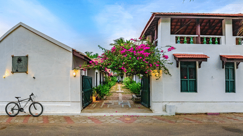 room cottage exterior view with cycle outside Neemrana's Coconut Alley - one of the best Tharangambadi hotels