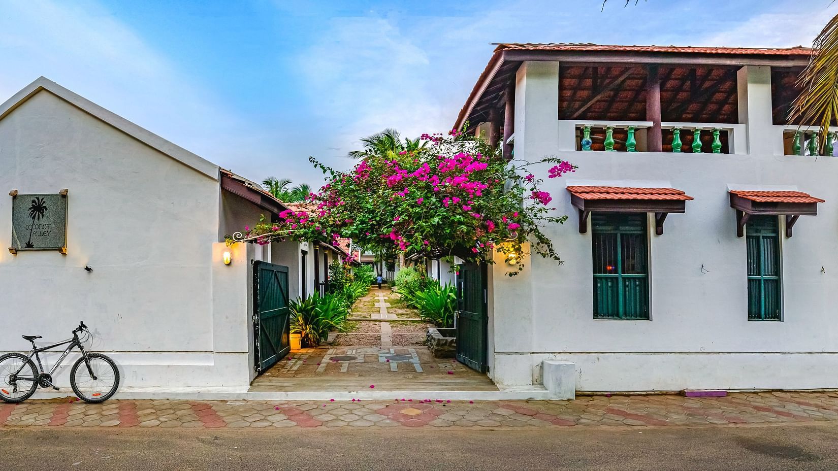 room cottage exterior view with cycle outside Neemrana's Coconut Alley - one of the best Tharangambadi hotels