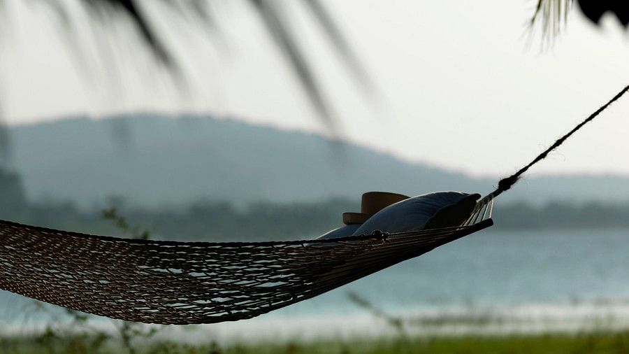 a person lying on a hammock 098