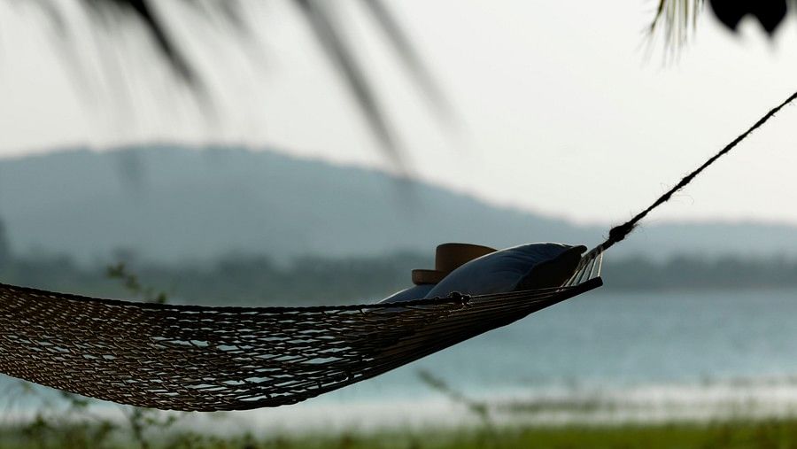 a person lying on a hammock