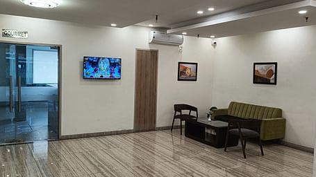 A sofa and a coffee table in the lobby section - Starlit Suites, Shirdi