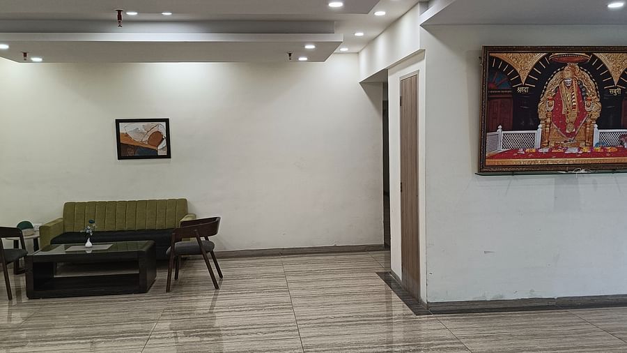 Sofa and a painting of Sai Baba in the lobby - Starlit Suites, Shirdi