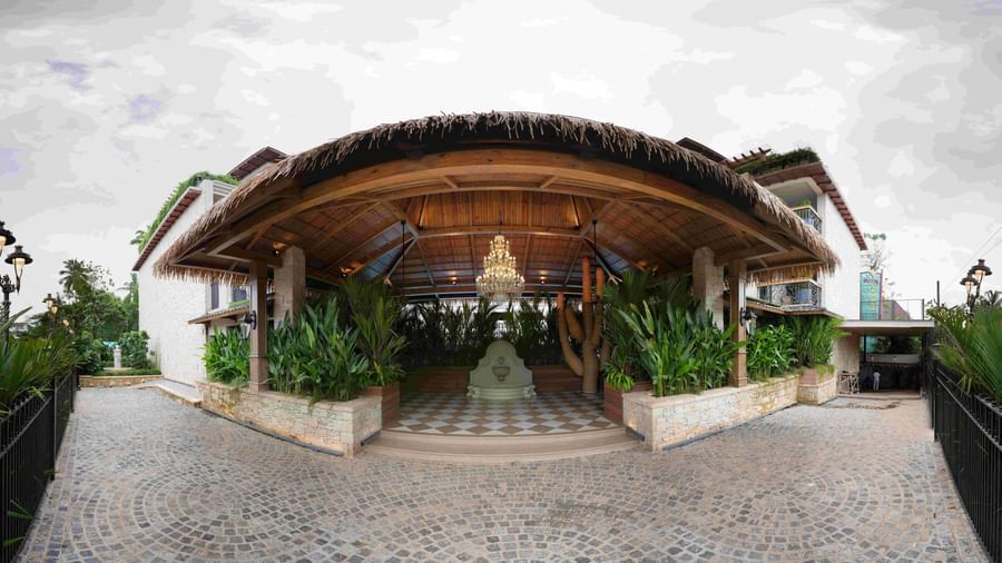 An ultra-wide angle shot of the entrance of The Evren, Vagator featuring  an empty drive way in front of it.