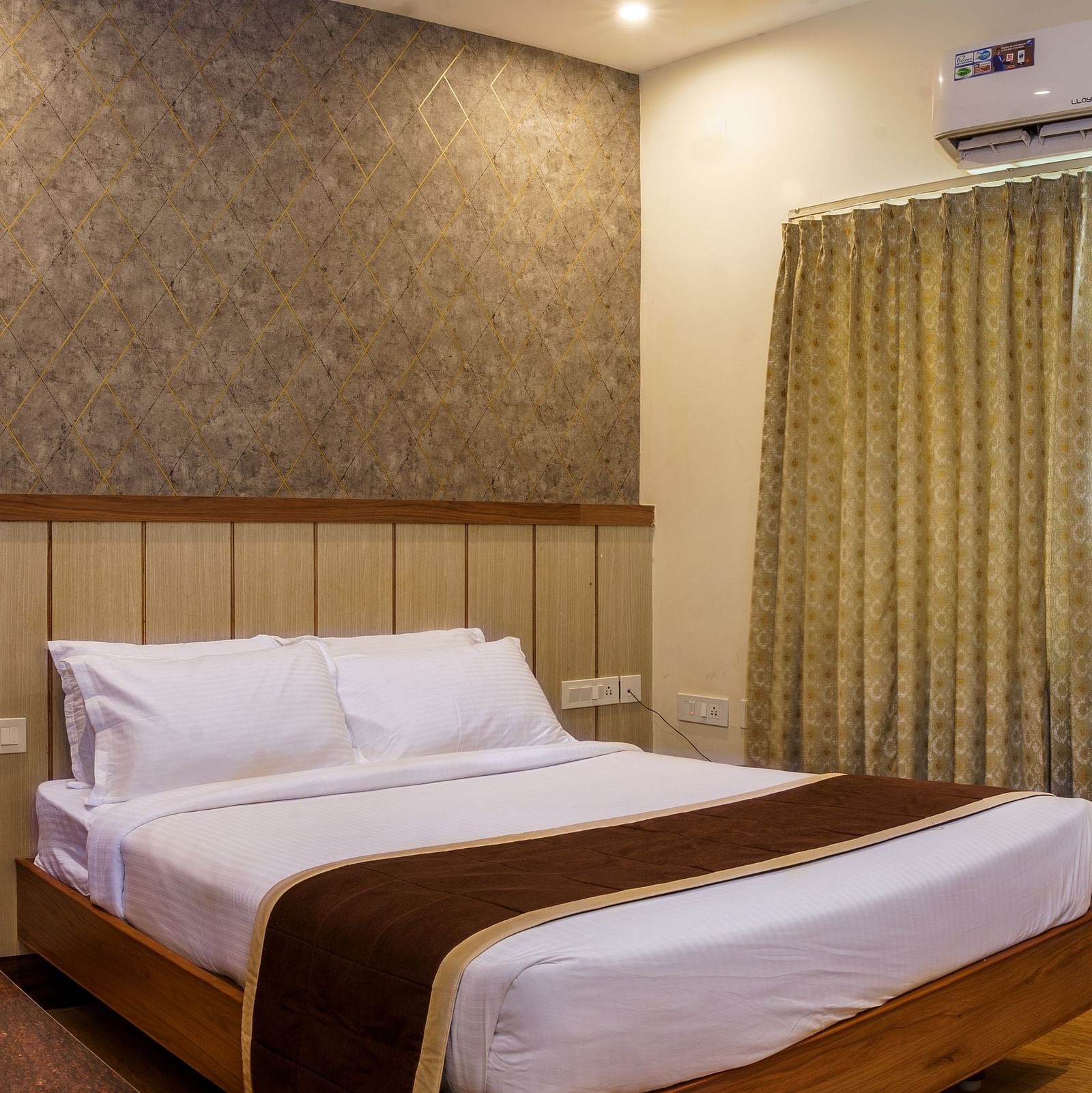 Side view of standard room with bed and study area at Wyt Hotels, Rameswaram