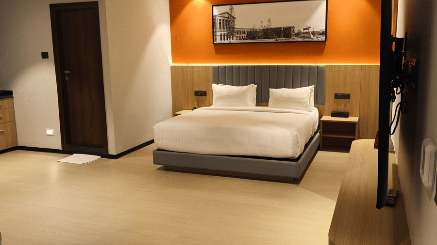 Luxury Suite Room at De Venetian by TGI combining a comfortable bedroom and stylish seating area.
