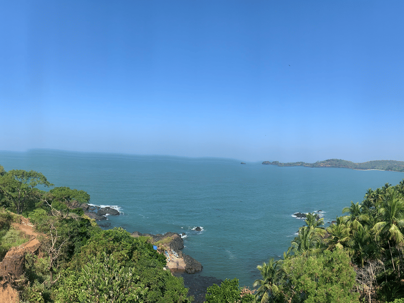 A panoramic view from the Cabo Da Rama Fort into the Arabian Sea with blue sky in the background.