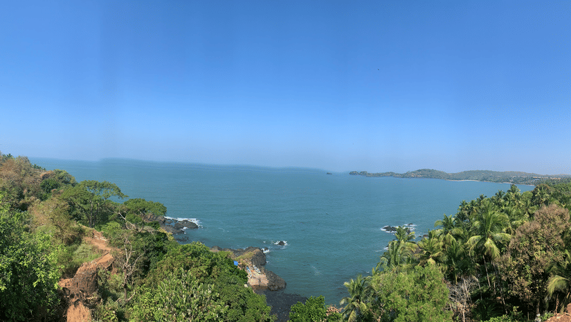 A panoramic view from the Cabo Da Rama Fort into the Arabian Sea with blue sky in the background.