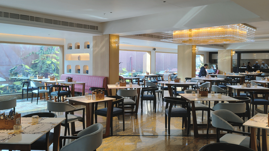 Different types of seating arrangements in a dining space at The Wild Fork restaurant in La Marvella, Bengaluru. 