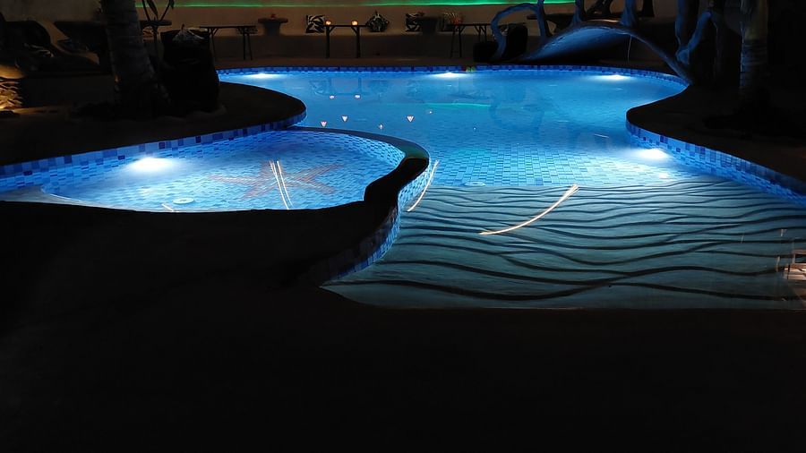 Illuminated pool at night, casting mesmerizing reflections - Matsya Island Retreat by Island Quest.