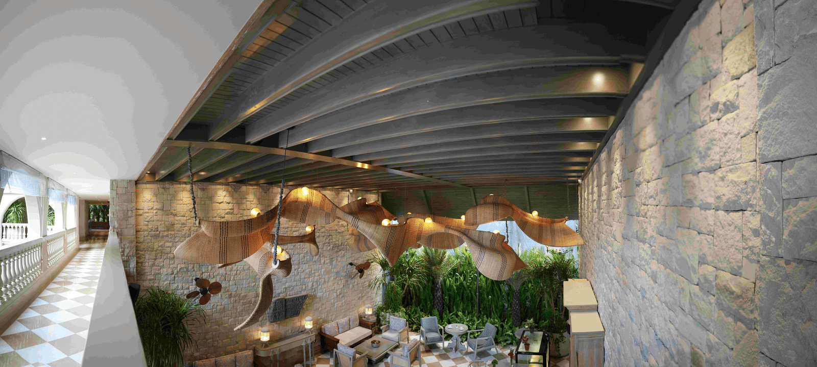 A wide-angle shot of the charming Suenos de Cafe at The Evren, Vagator, featuring a chequered floor, well-arrnaged seating, and a striking, large, woven light fixture.