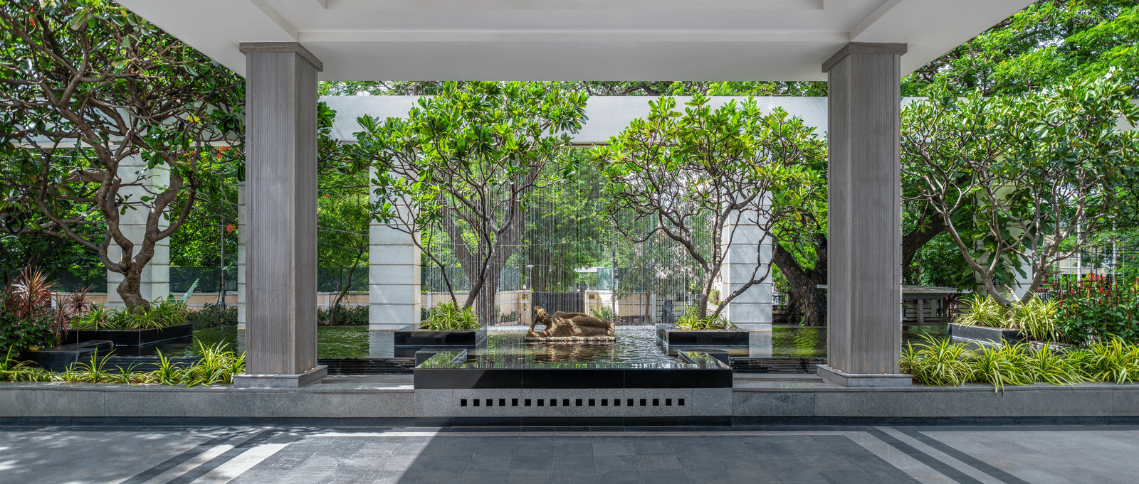 Covered driveway with seating and garden view at The Raintree, St. Mary’s Road.