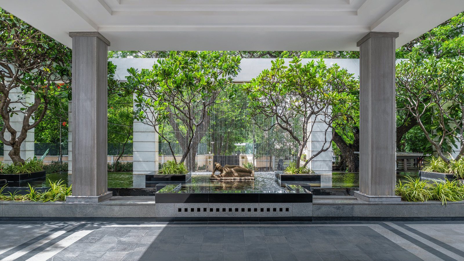 Covered driveway with seating and garden view at The Raintree, St. Mary’s Road.