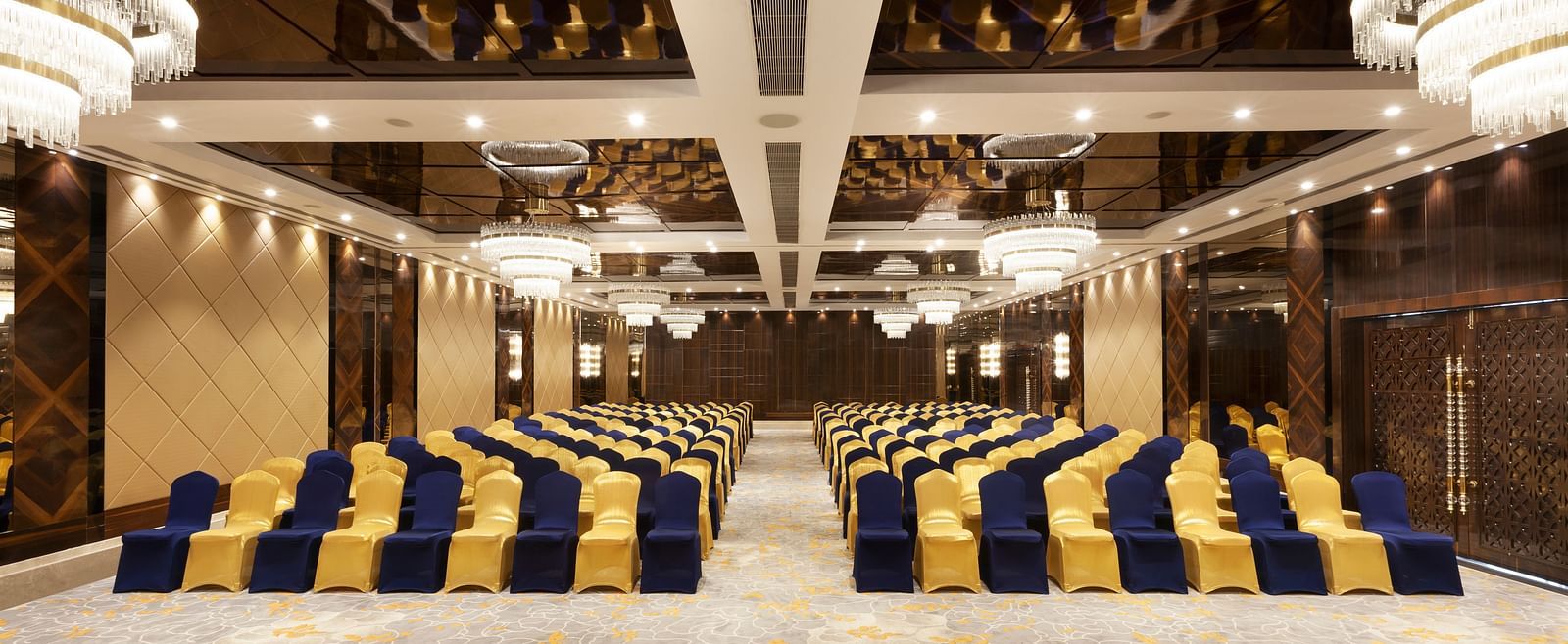 A front view of a banquet hall with chairs arranged on both sides and a pathway in between | Cenneys Gateway