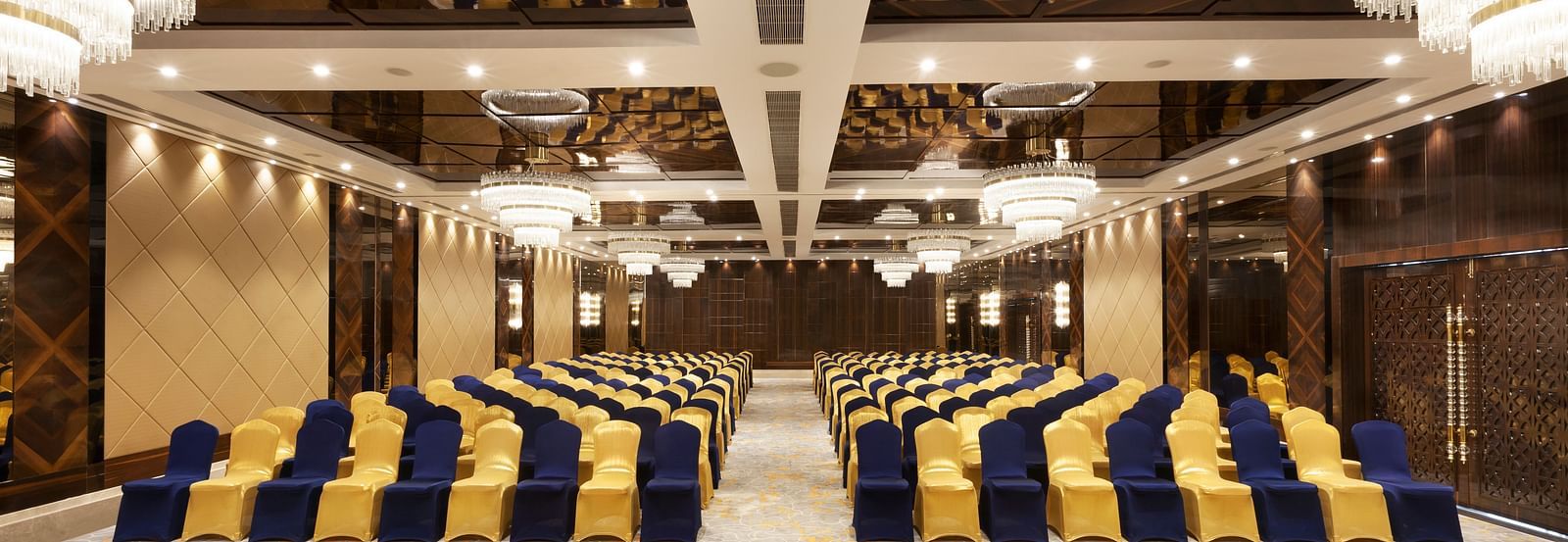 A front view of a banquet hall with chairs arranged on both sides and a pathway in between | Cenneys Gateway