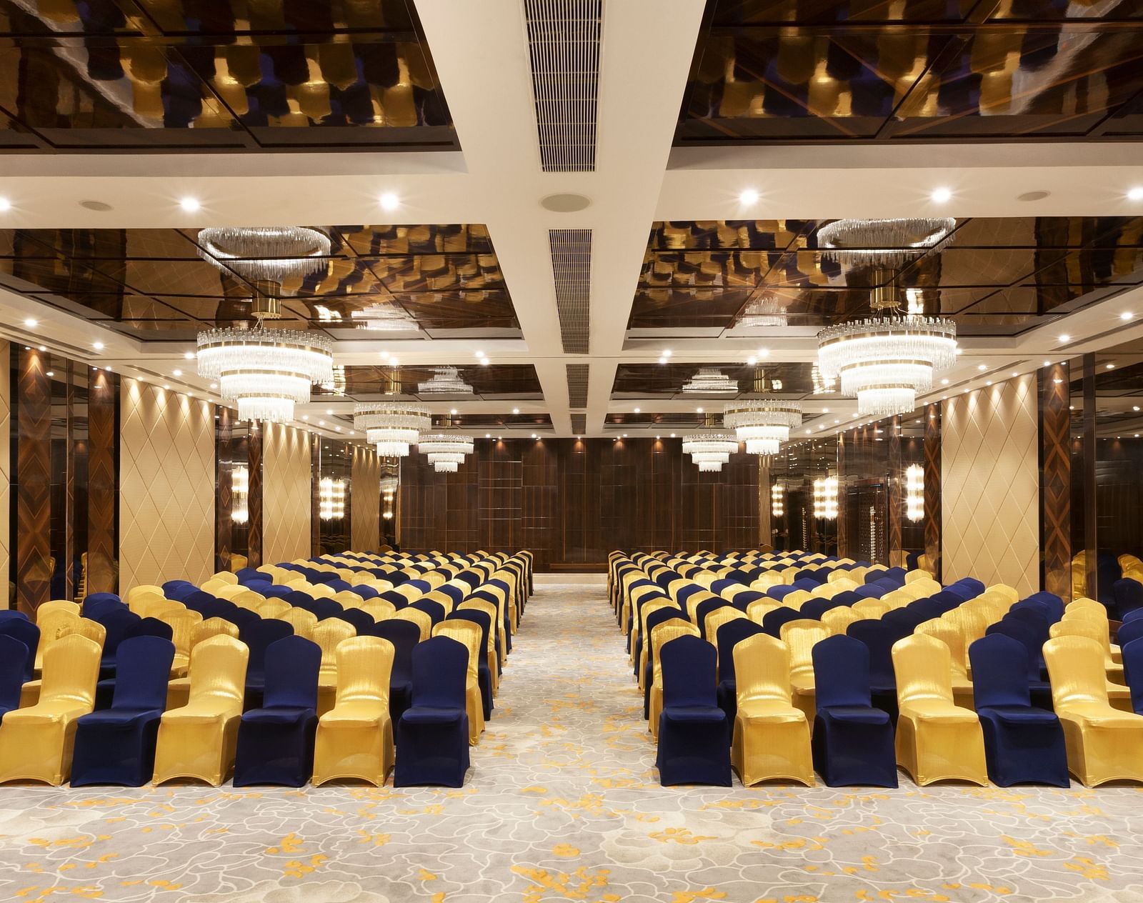 A front view of a banquet hall with chairs arranged on both sides and a pathway in between | Cenneys Gateway