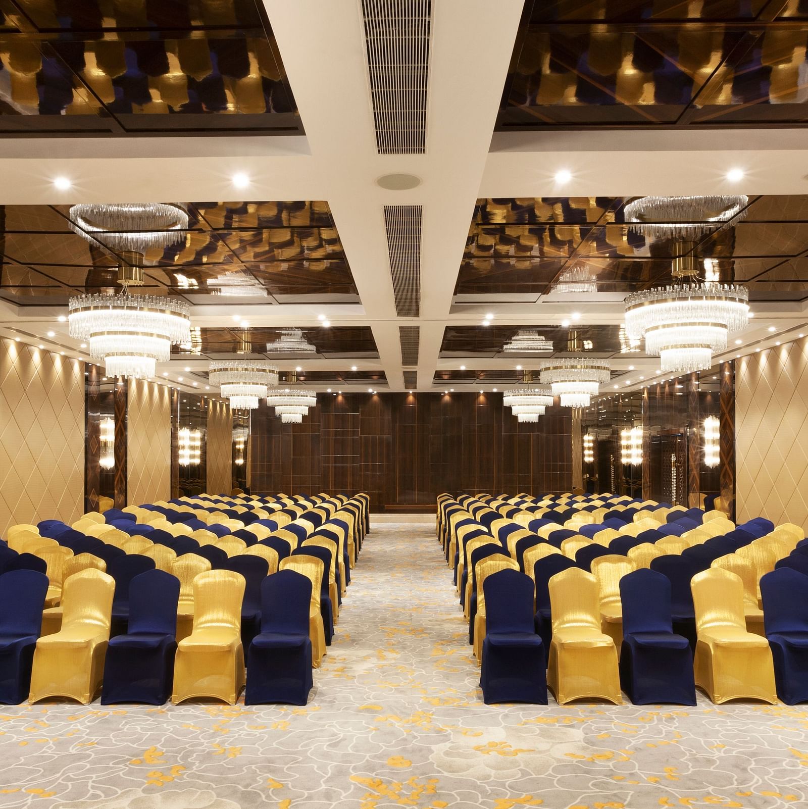 A front view of a banquet hall with chairs arranged on both sides and a pathway in between | Cenneys Gateway