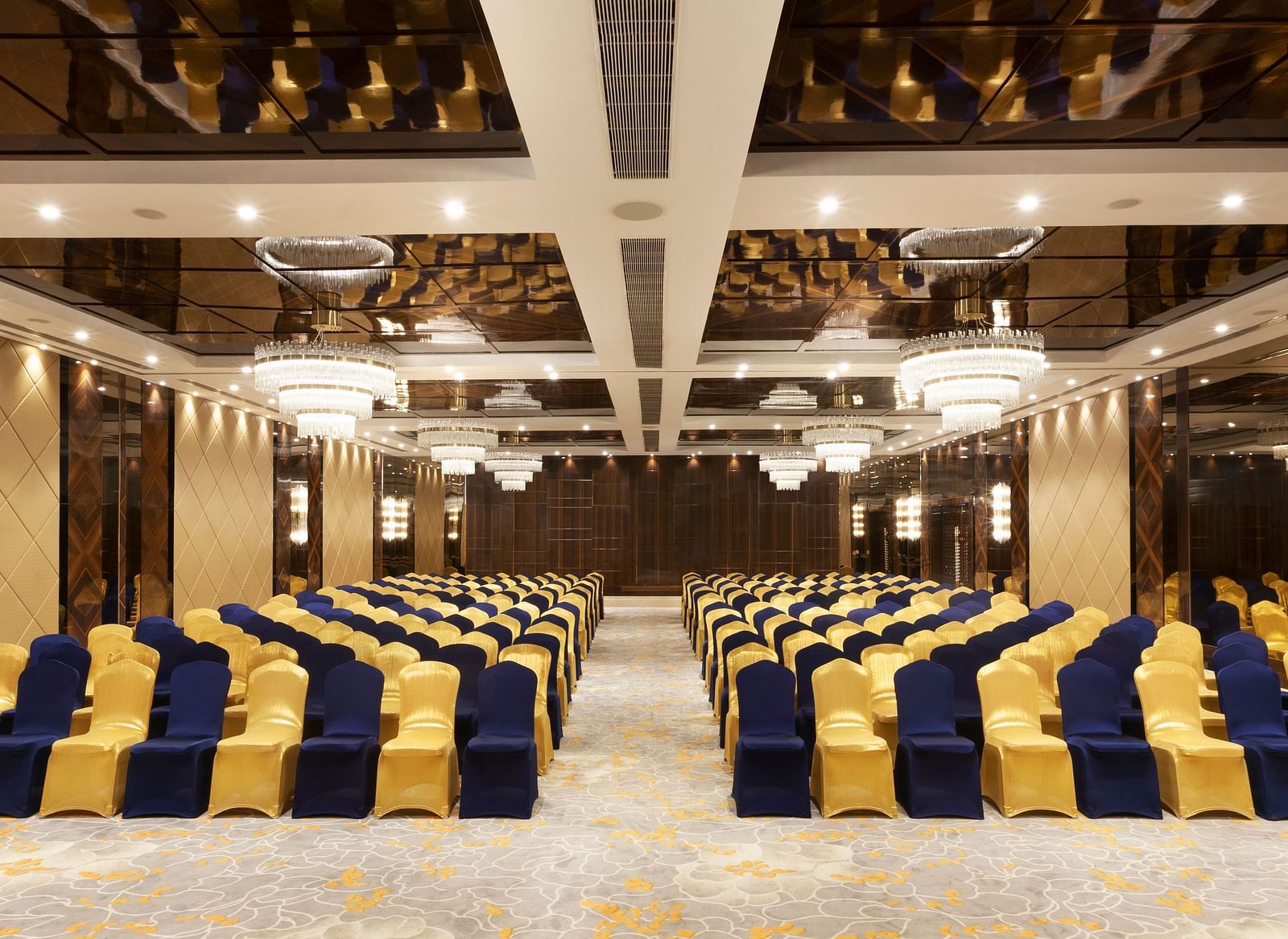 A front view of a banquet hall with chairs arranged on both sides and a pathway in between | Cenneys Gateway
