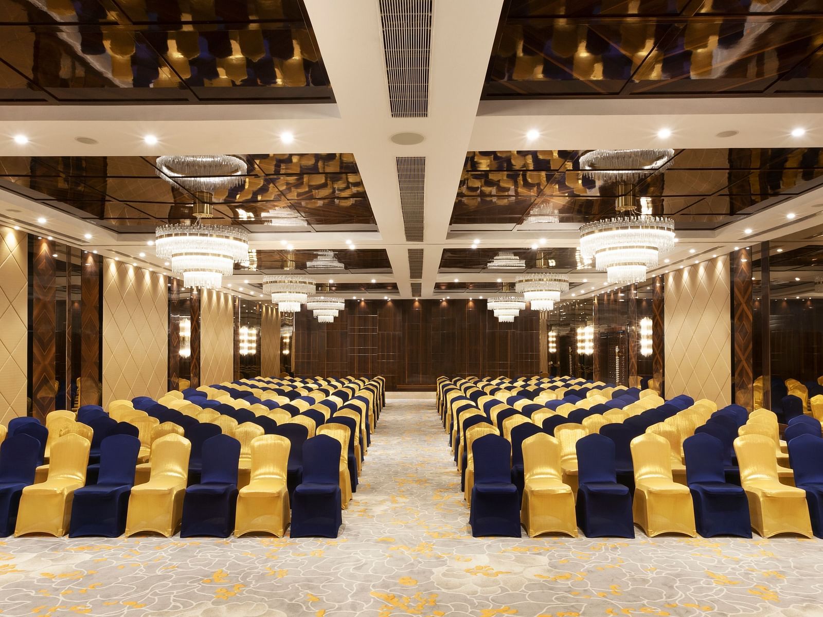 A front view of a banquet hall with chairs arranged on both sides and a pathway in between | Cenneys Gateway