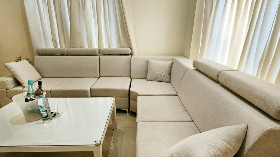 A close-up shot of the seating area featuring an L-shaped couch with a coffee table in front of it at Amara Villa, Nagoa.