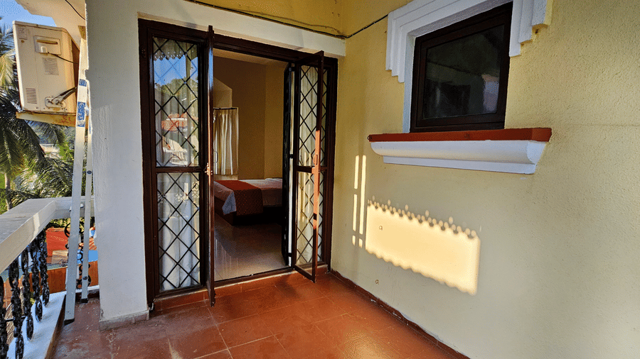 A door frame opening to a private balcony from one of the bedrooms of Amara VIlla, Nagoa.