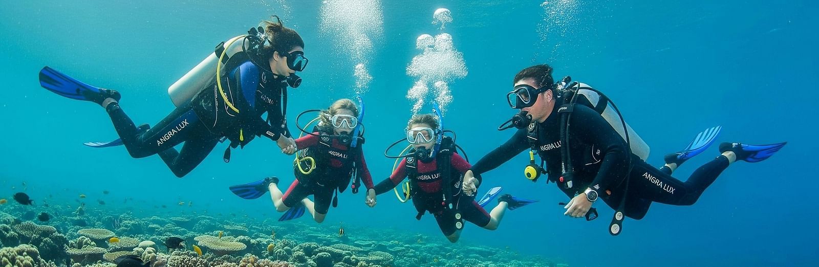 Group of divers swimming together beneath the ocean surface