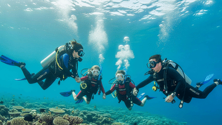 Group of divers swimming together beneath the ocean surface