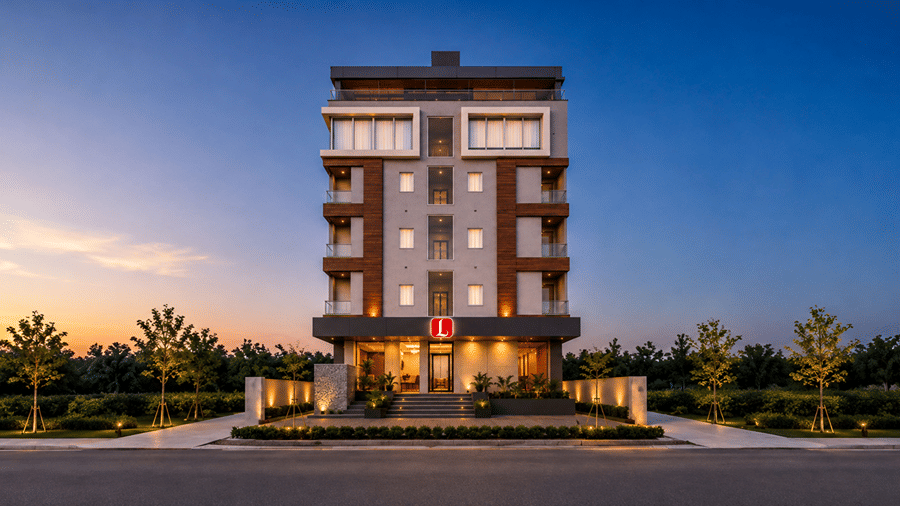 Front view of Lords Eco Inn Jawai-Sumerpur at dusk featuring a modern multi-story building with illuminated windows, small balconies, wooden architectural accents, and a lined driveway with trees under a clear twilight sky.