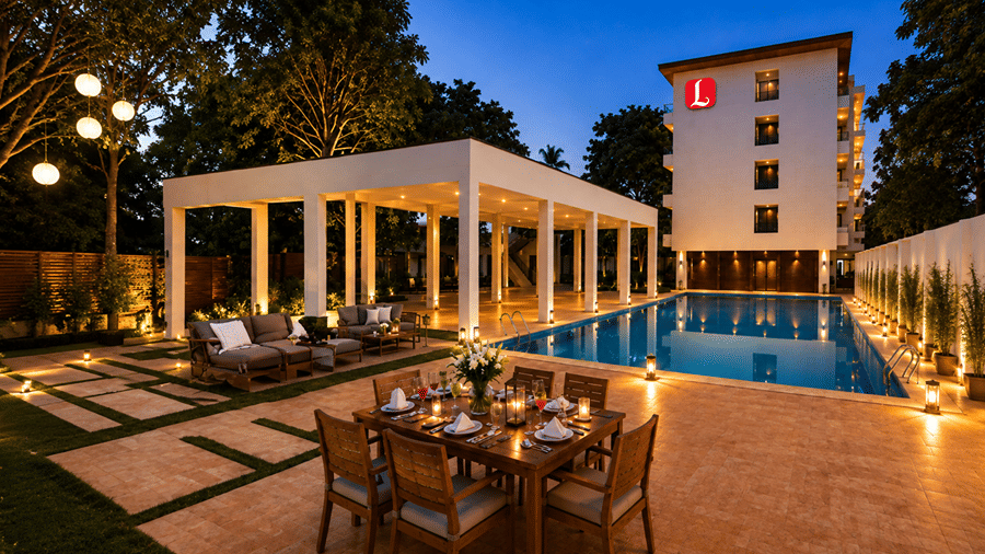 Outdoor area of Lords Riverside Resort, Muduba  featuring an illuminated swimming pool, a covered pavilion with outdoor seating, dining set, and a multi-story hotel building in the background at dusk.