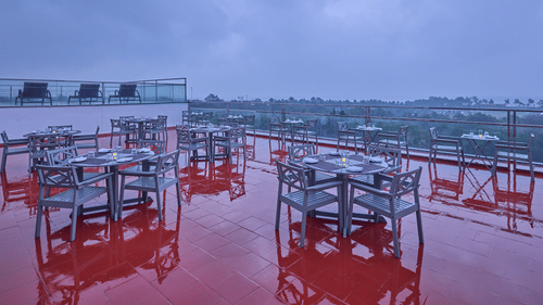 chairs and tables overlooking the city at our rooftop restaurant in Mahabalipuram - Grand Continent, Mahabalipuram 