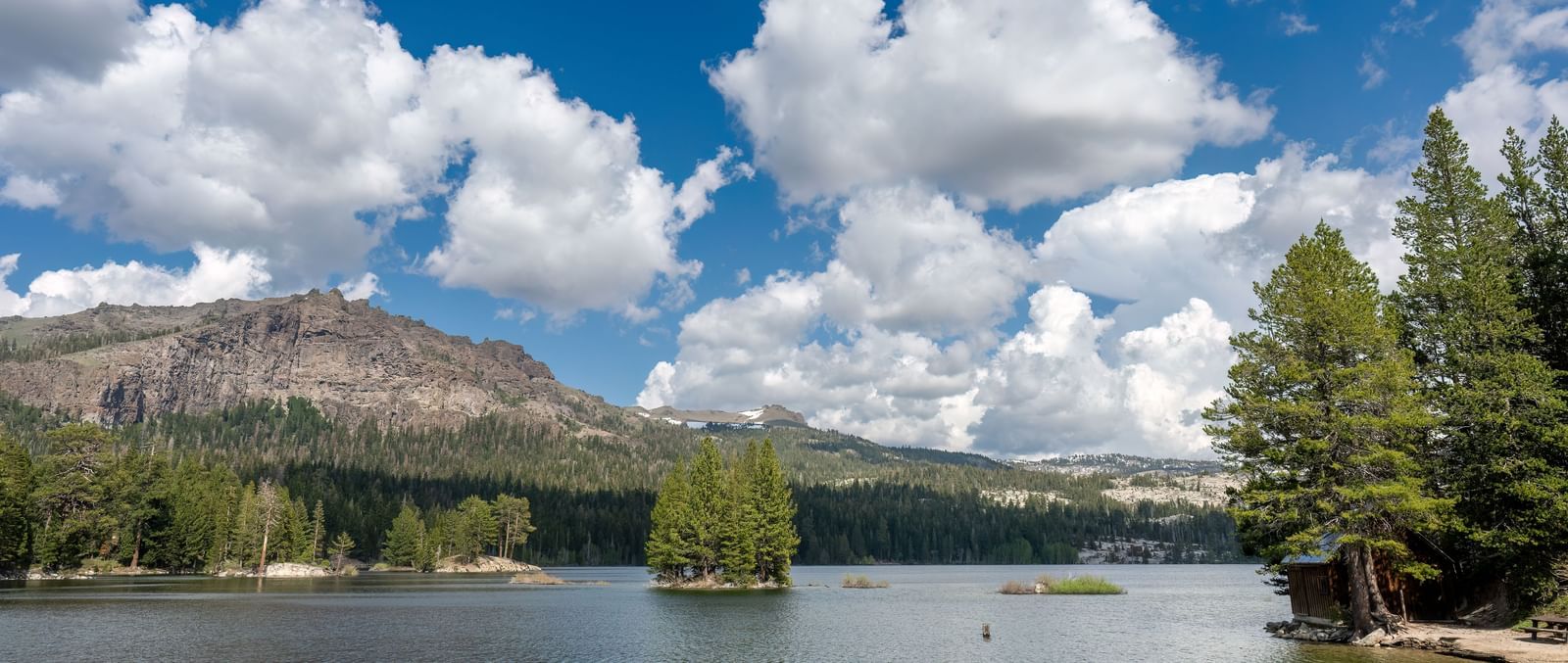 Stunning lake and mountain view under a bright sky near Kit Carson Lodge.