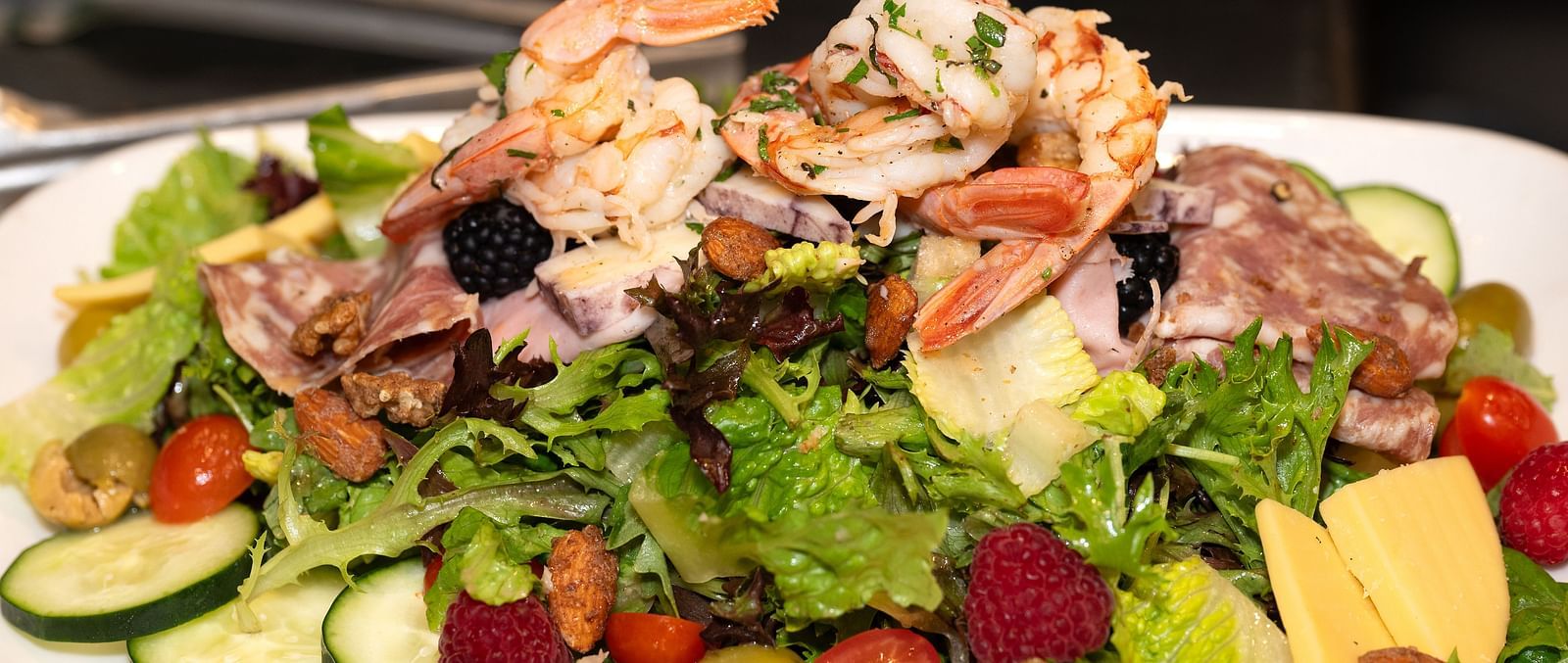 Fresh seafood salad with prawns, greens, vegetables, and fruit at The Groveland Hotel.