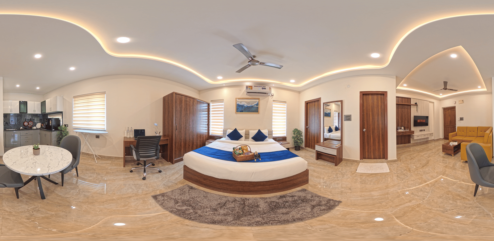 A 360-degree panorama shows a room with a round bed, a table, and ceiling lights at Elysium Studio Suites, Madhapur.