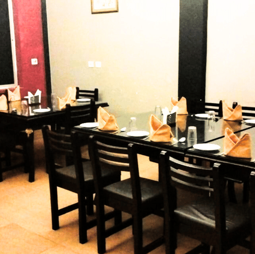 A well-lit dining space with neatly arranged tables