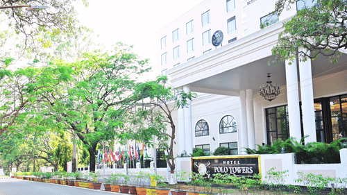 Facade view of the entrance to Polo Hotel Agartala with trees in the foreground