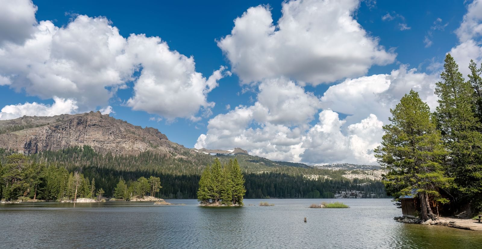 Stunning lake and mountain view under a bright sky near Kit Carson Lodge.