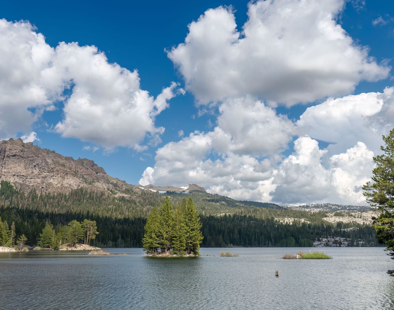 Stunning lake and mountain view under a bright sky near Kit Carson Lodge.