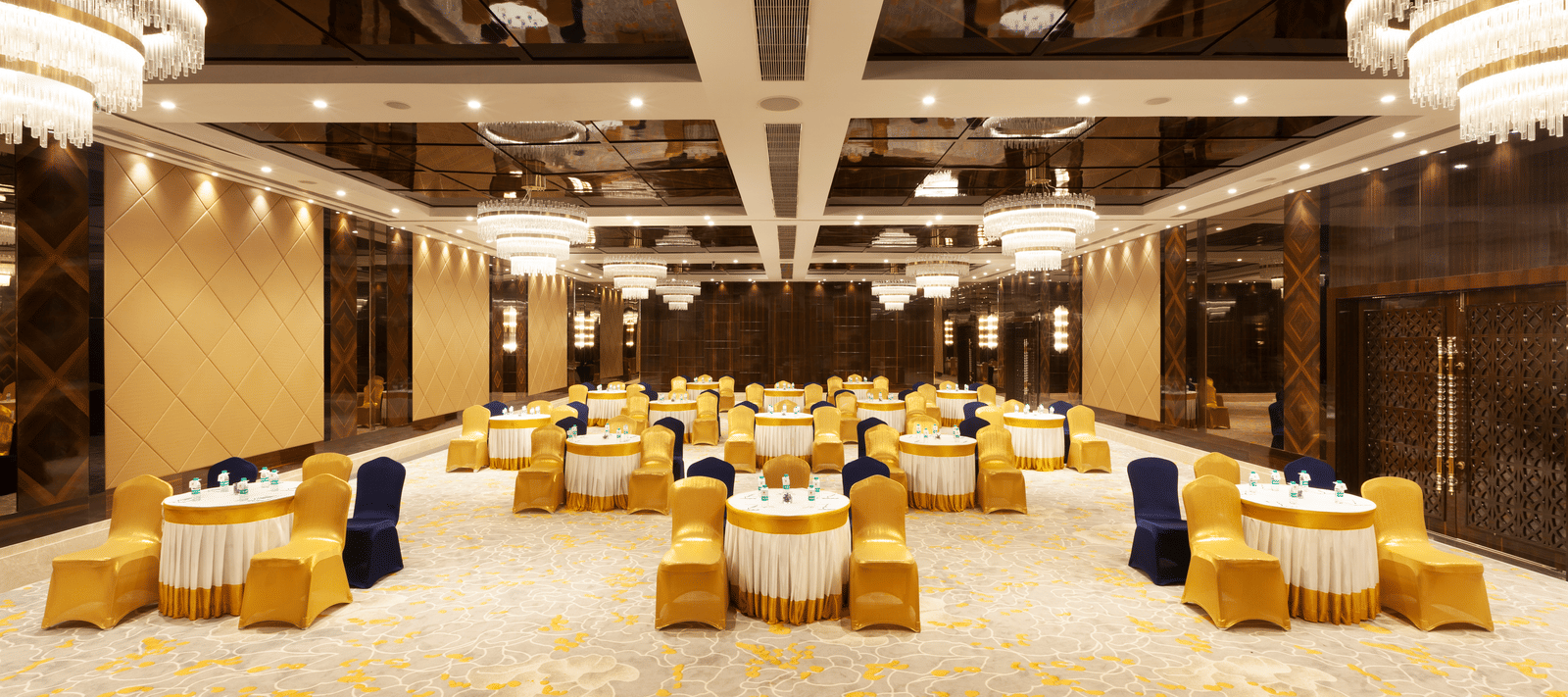 A banquet hall with round tables and chairs neatly arranged around them | Cenneys Gateway